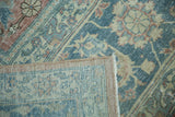 Distressed blue and beige Tabriz rug pile showing hand-knotted foundation.
