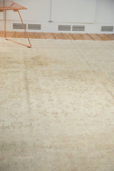 Distressed vintage Oushak rug detail with soft ivory, blush, and faded vinery pattern.