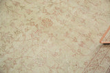 Distressed pile of vintage Oushak rug with ivory field and blush pink vinery.