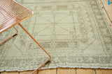 Distressed vintage Oushak runner with faded geometric patterns in ivory and pale brown.