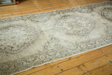 Distressed vintage Sparta runner with faded traditional patterns and muted beige tones.
