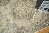 Distressed texture and faded beige, brown Oushak-inspired patterns on a vintage Sparta rug.