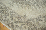 Worn texture of distressed vintage Sparta runner in muted beige and brown tones.