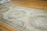 Distressed vintage Sparta rug runner, faded beige pile, soft texture, classic border pattern.