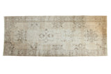 Hand knotted vintage distressed Sparta runner rug with beige, silver, and charcoal starburst medallions.