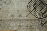 Distressed beige and charcoal patterns on fringed end of a vintage Sparta runner.