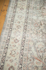 Distressed vintage Sivas carpet with faded palmettes, scrolling vines, and exposed knot-head texture.