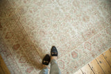 Distressed vintage Oushak carpet, soft pile with faded ivory, blush, and sea foam florals.