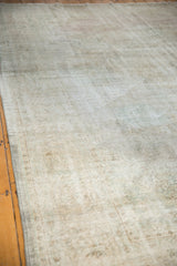Vintage distressed Oushak rug with even wear, visible foundation, and soft ivory tones.