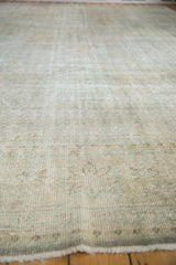 Textured pile of distressed vintage Oushak carpet, revealing foundation and soft neutral tones.