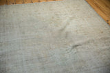 Visible foundation and lazy lines on a distressed vintage Oushak rug in muted ivory tones.