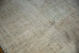 Distressed texture of vintage Oushak rug, showing heavy foundation in muted ivory and green.