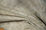 Worn pile texture of a distressed vintage Oushak carpet, revealing foundation and muted colors.