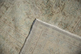 Close-up of vintage distressed Oushak carpet pile, exposing hand-knotted foundation and secured edge.