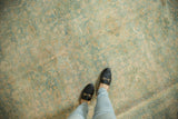 Vintage distressed Meshed carpet with soft, faded blue-green and pale gold patterns.