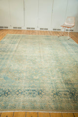 Distressed main border of vintage Persian Meshed rug, featuring elongated floral cartouches.