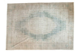 Decorative vintage distressed Oushak rug with faded ocean green medallion and neutral geometric borders.