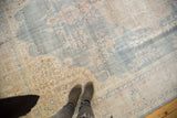 Distressed vintage Oushak rug with faded powder blue field and ivory rococo floral arabesques.