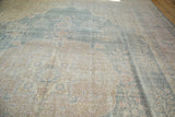 Distressed Oushak carpet displaying rococo style floral arabesques in faded powder blue, ivory.