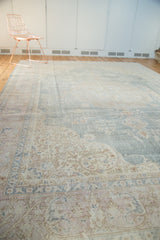 Close-up of distressed corner spandrel with rococo-style arabesques in pale blue and ivory.