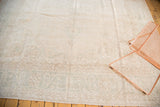 Vintage distressed Oushak carpet with airy ivory and pale coffee brown faded patterns.