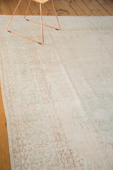 Vintage distressed Oushak carpet with faded pattern in ivory and pale coffee brown tones.