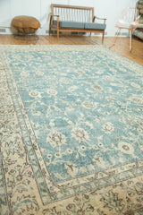 Vintage Oushak rug corner: faded blue-green field, worn texture, pale apricot border.