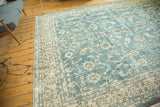 Distressed vintage Oushak carpet with faded ocean blue-green field, showing worn palmette and lotus patterns.