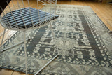 Distressed Kula carpet featuring charcoal and ivory geometric floral interpretations with abrashes.