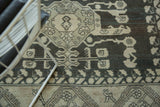 Detail of geometric floral designs with samovar contouring and abrashes in charcoal and ivory.