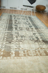 Distressed Kula carpet showing pronounced abrashes and geometric floral patterns.