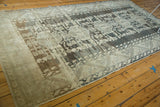 Distressed geometric border, charcoal and antique ivory abrashes on vintage Kula rug.
