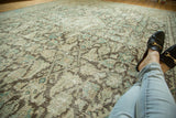 Distressed texture of the vintage Mahal rug's Herati motif in muted beige, brown, and teal.