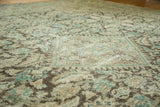 Worn beige, brown, and teal Herati motif on distressed vintage Mahal rug.