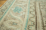Evenly worn distressed pile featuring sand, beige, and teal Herati motifs on a vintage Mahal rug.