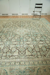 Distressed pile of vintage Mahal rug showing intricate Herati motif in charcoal, beige, and teal.