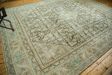 Distressed corner of a Vintage Mahal rug, showing worn pile and Herati motif in brown and teal.