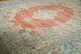Worn floral medallion and distressed terra cotta field on a vintage Arak carpet.