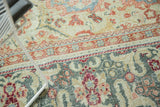 Vintage Distressed Arak carpet pattern detail with teal, vivid rust, and ivory floral motifs.
