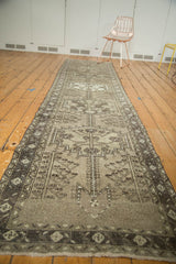 Secured end of the vintage Northwest Persian runner, featuring geometric charcoal and antique ivory motifs.