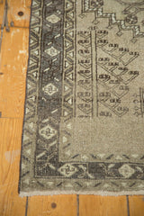 Vintage Northwest Persian runner's fringed end, secured side, and charcoal geometric border.