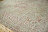 Graceful meandering vine border in raspberry on a sand-toned vintage distressed Persian rug.