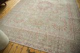 Subtle abrashes on a vintage Persian carpet with a raspberry red and sand millefleur pattern.