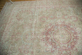 The distressed texture of the roundel medallion and millefleur field in raspberry red and sand.