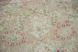 Close-up of the distressed Persian carpet's trefoil pawn and millefleur motifs.