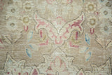 A trefoil pawn motif with raspberry and blue details on the distressed, low pile.