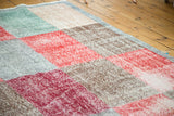 Funky, distressed multi-paneled Oushak carpet in faded reds, beige, and ocean green.