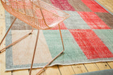Distressed multi-paneled Oushak rug with faded red, ocean green, and beige.