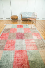 Localized wear on an ocean green panel of this distressed Oushak carpet.