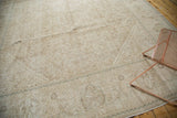 Distressed texture and trefoil border details in muted tones on this vintage Mahal rug.